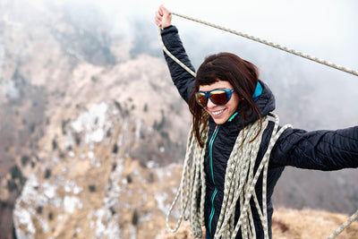 Rudy Project Stardash sunglasses worn by woman single butterfly coiling climbing rope in the mountains