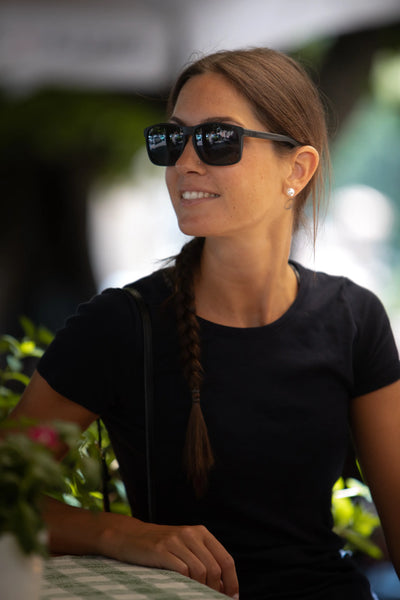 Smiling woman wearing Rudy Project Overlap active lifestyle sunglasses made of sustainable material Rilsan that is derived from castor bean oil