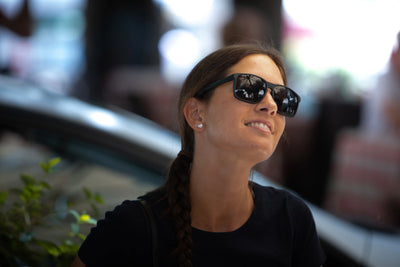 Woman wearing Rudy Project Overlap active lifestyle sunglasses made of sustainable material Rilsan that is derived from castor bean oil