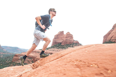 Rudy Project Agent Q sunglasses worn by man hiking on red rocks of United States desert southwest