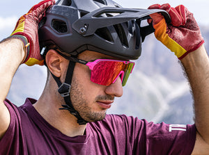 Mountain biker wearing Rudy Project Protera+ helmet with adjustable visor and goggle clip, and also Spinshield Air wide shield sunglasses