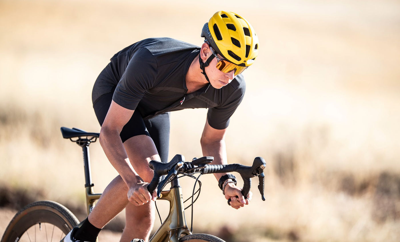 Male gravel cyclist wearing Rudy Project Spinshield Air sport performance active lifestyle sunglasses and Skudo helmet